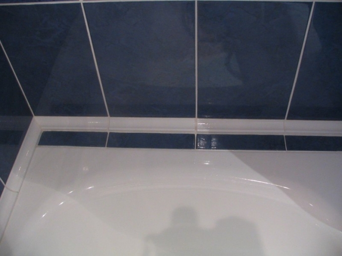 В месте соприкосновения ванны со стеной часто образуется плесень или потемнения
